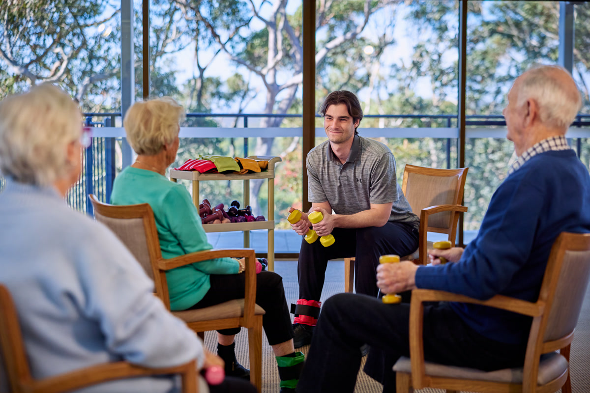 Reignite Health physiotherapist leading a small group exercise session with residents